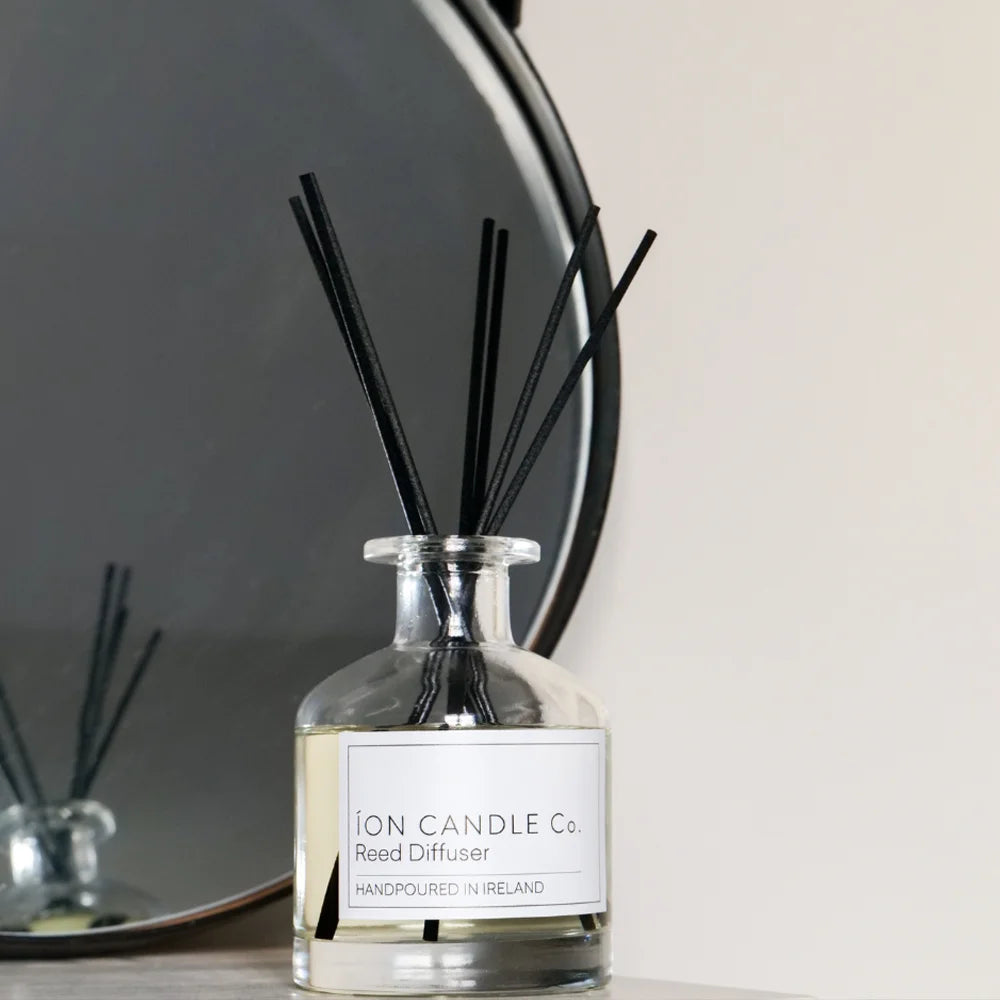 Ion Candle Co. - Reed Diffuser bottle sat against a white background with a circular mirror to the left