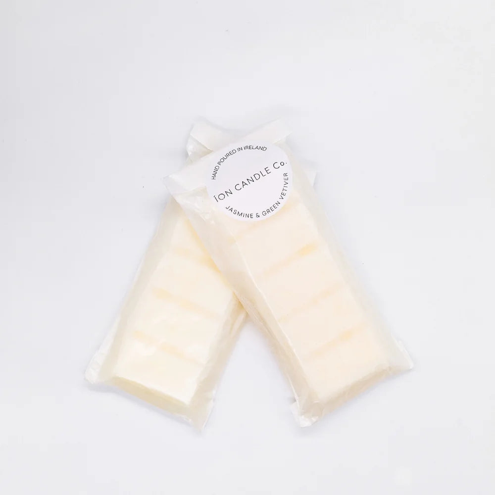 Ion Candle Co. - Luxury scented jasmine and green vetiver wax melts, in their white paper packaging against a white background