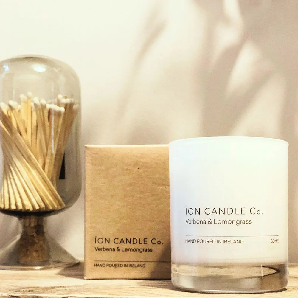 Ion Candle Co. - Luxury scented verbena & lemongrass candle next to its packaging which is a simple cardboard box with black text.