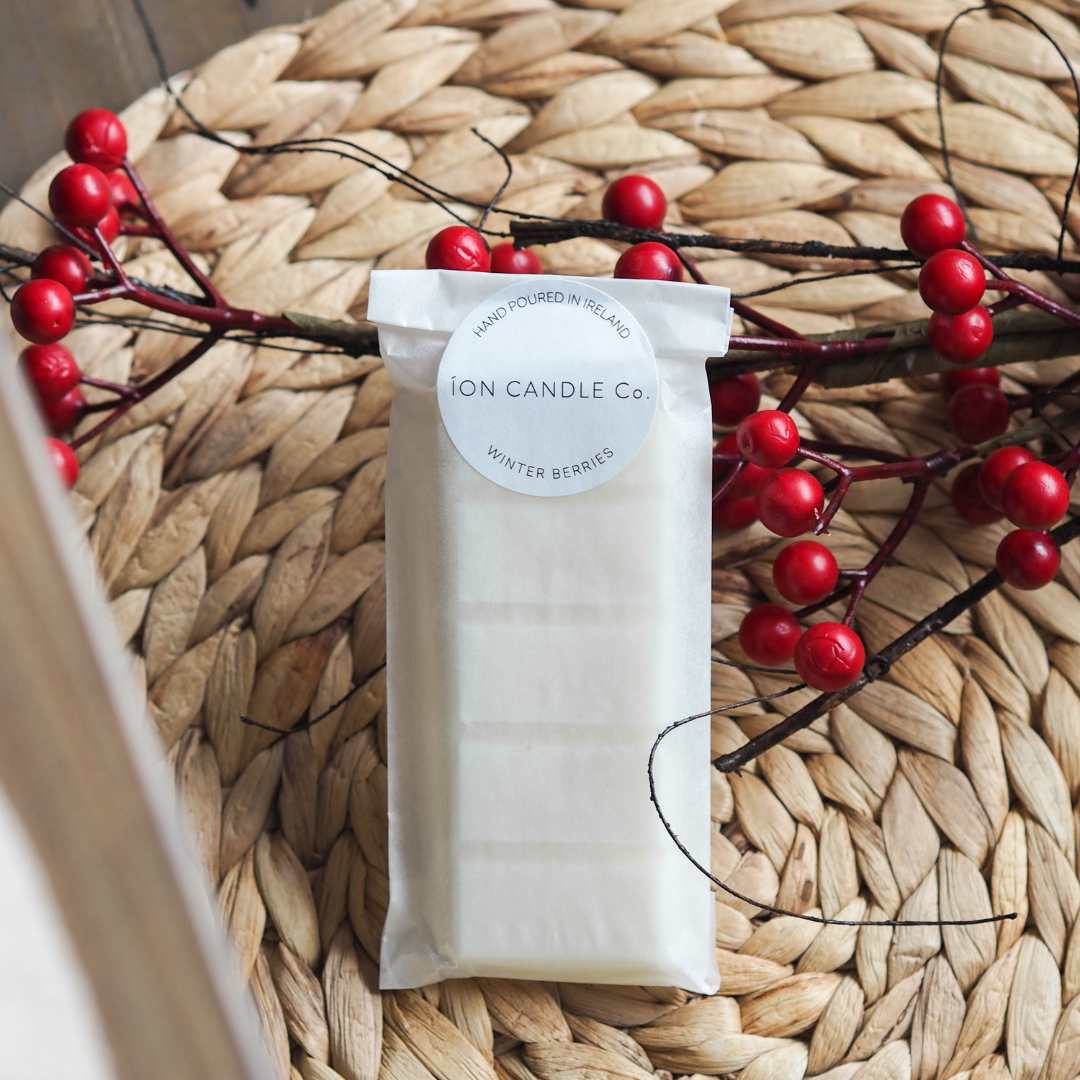 Luxury scented Winter bwerries wax melt laying flat dressed with red berries on rattan placeholder