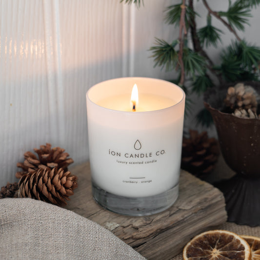 Candle from Ion Candle Co. on a wooden surface with decorative elements