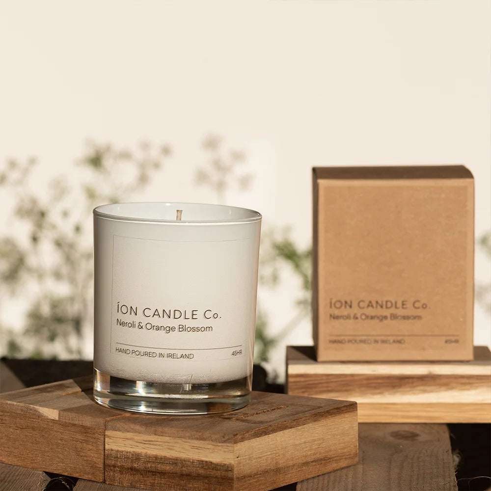 Ion Candle Co. - Neroli & Orange blossom luxury scented candle, against a floral background