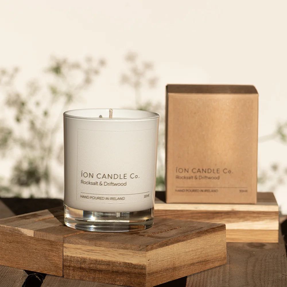 Ion Candle Co. - luxury scented rocksalt & driftwood candle against a floral background