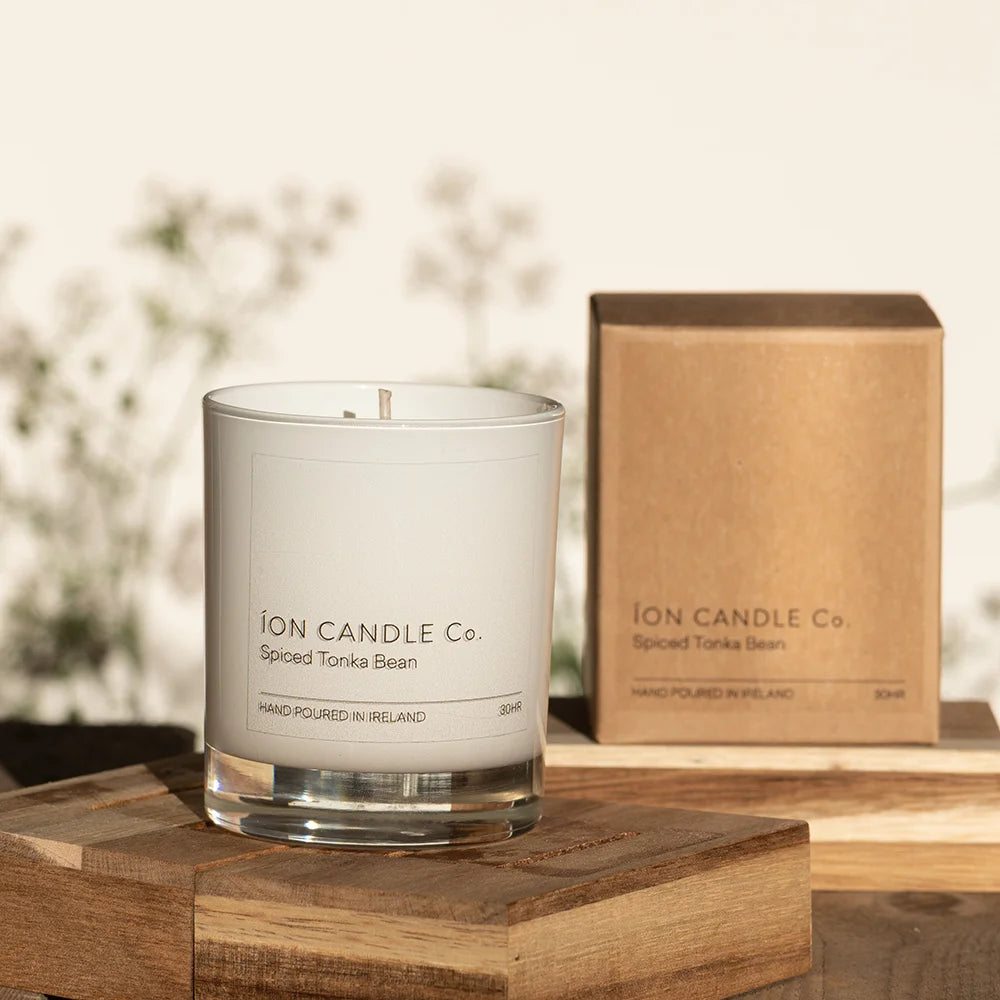 Ion Candle Co. - Luxury scented spiced tonka bean candle against a floral background