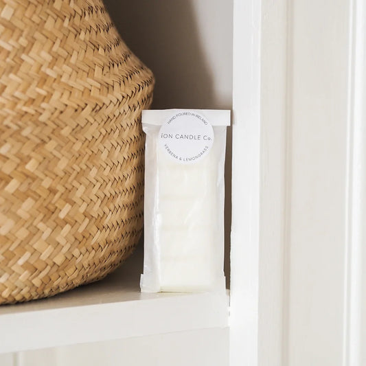 Ion Candle Co. - Luxury scented verbena and lemongrass wax melt, leaning against a wicker straw basket with a white background