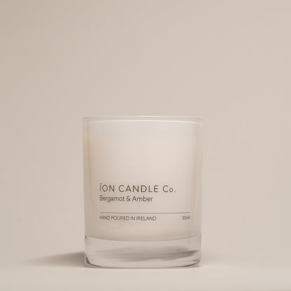 Ion Candle Co. - Bergamot & Amber luxury scented candle against a beige background