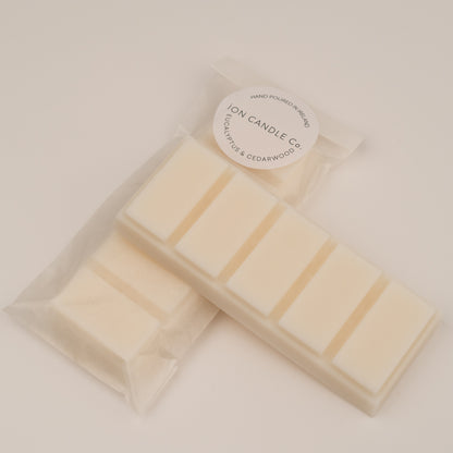 Ion Candle Co. - Eucalyptus and Cederwood Luxury Wax Melts, in their white paper packaging placed on a white background