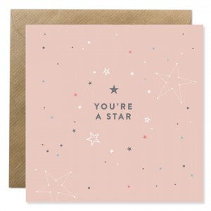 Ion Candle Co. - Pink Greeting card with various sized stars of multiple colours and designs scattered around text in the centre of the card that reads 'You're A Star'.